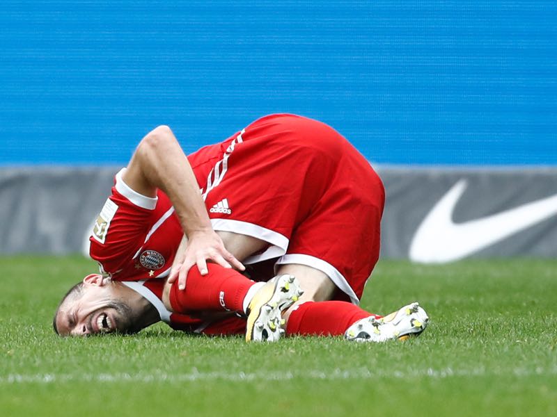 Frank Ribéry holds his left knee just moments after hyperextending the joint. (ODD ANDERSEN/AFP/Getty Images)