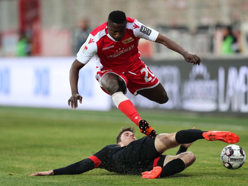 Suleiman Abdullahi of FC Union Berlin is challenged by Maximilian Thalhammer of SSV Jahn Regensburg during the Second Bundesliga match between 1. FC Union Berlin and SSV Jahn Regensburg at Stadion An der Alten Foersterei on April 12, 2019 in Berlin, Germany. (Photo by Boris Streubel/Bongarts/Getty Images)