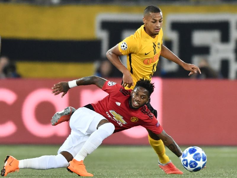 Young Boys Swiss midfielder Djibril Sow (R) fights for the ball with Manchester United's Brazilian midfielder Fred (C) during the UEFA Champions League group H football match between Young Boys and Manchester United at The Stade de Suisse in Bern on September 19, 2018. (Photo by Fabrice COFFRINI / AFP) 