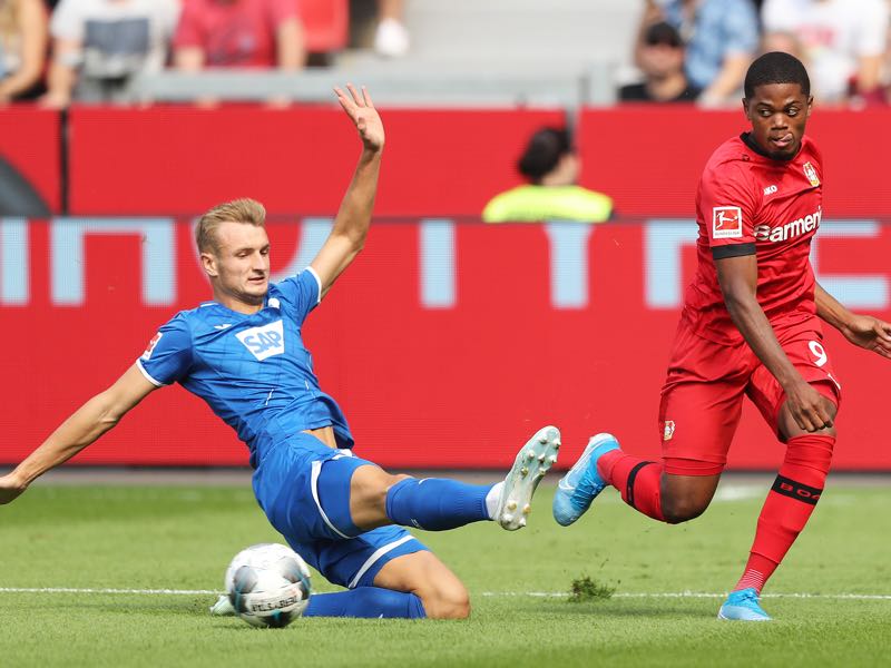 Bayer Leverkusen v Hoffenheim - Leon Bailey of Bayer 04 Leverkusen shoots past Stefan Posch of TSG 1899 Hoffenheim during the Bundesliga match between Bayer 04 Leverkusen and TSG 1899 Hoffenheim at BayArena on August 31, 2019 in Leverkusen, Germany. (Photo by Christof Koepsel/Bongarts/Getty Images)